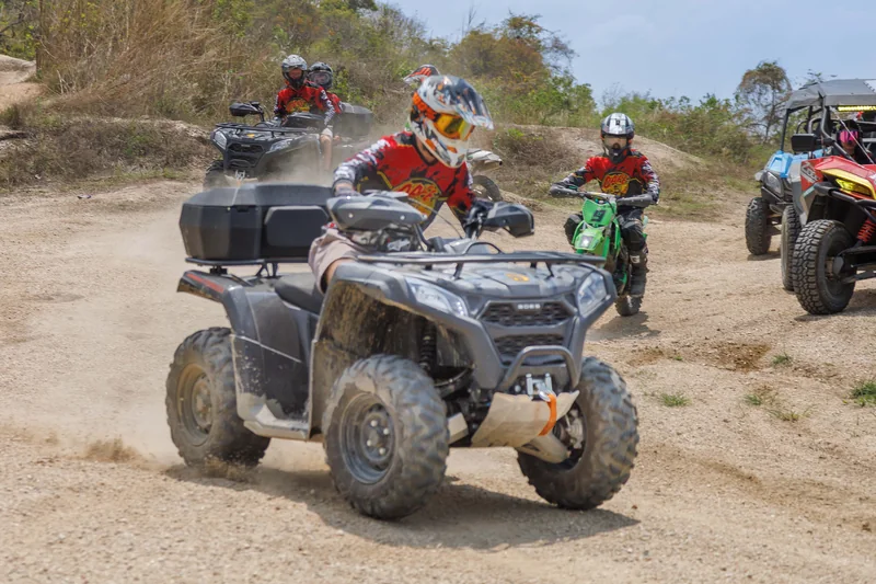 ATVs and dirt bikes gathered at the trail start
